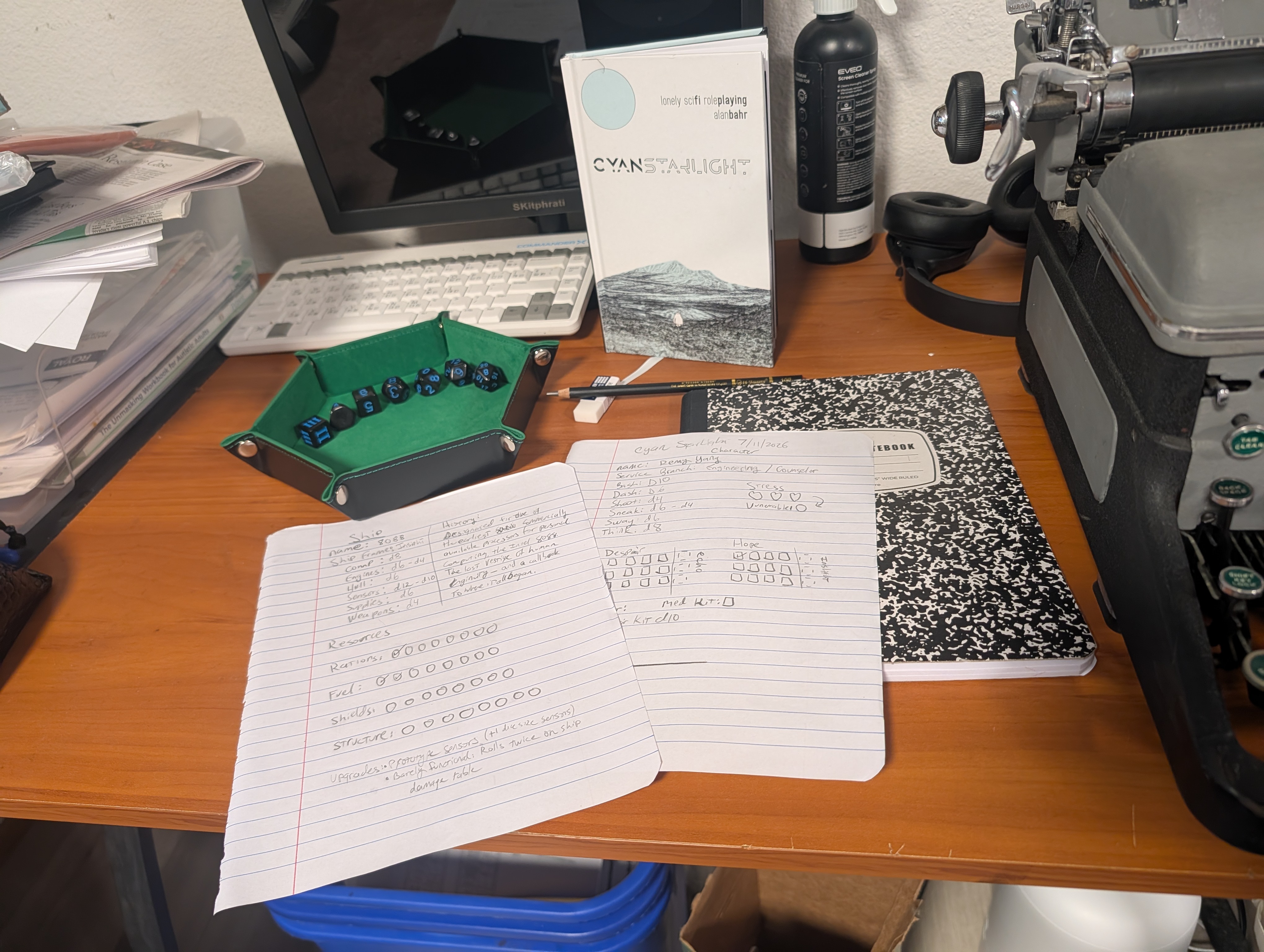 Desk with Cyan Starlight game play materials and other miscellany